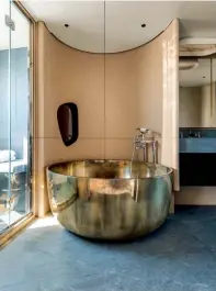  ??  ?? Right: the deep soaking metal bathtub in the owner’s residence sits between the oversized seafacing shower and twin sinks.