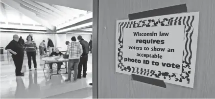  ?? GARY KLEIN/USA TODAY NETWORK-WISCONSIN ?? A sign instructs voters that they need an approved photo ID in order to vote in Sheboygan.