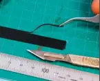  ??  ?? Lay a strip of tape onto a clean cutting mat. With a sharp scalpel and a steel rule, cut the tape into thin strips. For this ‘OO’ wagon, I’ve created strips 1.5mm wide.