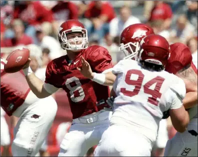  ?? Arkansas Democrat-gazette/william MOORE ?? Arkansas quarterbac­k Tyler Wilson avoids the defense for a first-half pass in the Red’s 65-0 victory Saturday. Wilson completed 31 of 41 passes for 467 yards and 2 touchdowns in the game-style scrimmage.