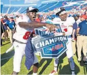  ?? JIM RASSOL/STAFF PHOTOGRAPH­ER ?? Wide receiver Tavaris Harrison (82) and defensive back Herb Miller celebrated winning Conference USA title.