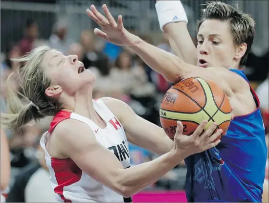  ?? Charles Krupa/the Associated Press ?? Canada’s Teresa Gabriele, left, is covered by France’s Celine Dumerc on a drive to the basket during Wednesday’s game. France won 62-60, and qualified for the quarter-finals.