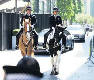  ??  ?? ●●Police horses escort guests through Spinningfi­elds to the crown court