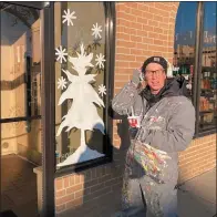  ?? ?? Artist Lisa Littill has already painted several dozen holiday themed murals on downtown business’s windows with more to come.