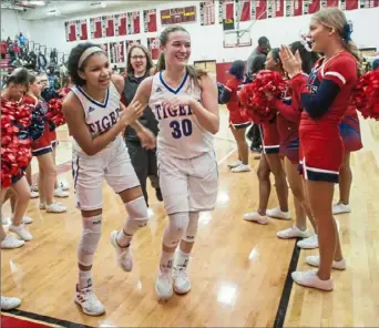  ??  ?? McKeesport’s Laila Taylor, left, and Brianna Evans laugh as they leave the court after beating Greensburg Salem 51-37 in the WPIAL Class 4A girls basketball playoffs Monday.