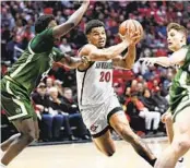  ?? DENIS POROY FOR THE U-T ?? Aztecs guard Matt Bradley drives between Colorado State’s Isaiah Stevens (4) and Patrick Cartier.