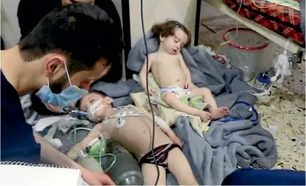  ?? PHOTO: AP ?? This image made from video released by the Syrian Civil Defence White Helmets, which has been authentica­ted based on its contents and other AP reporting, shows medical workers treating toddlers following an alleged poison gas attack in the...