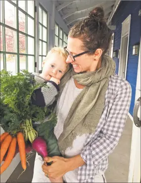  ?? Rosemary Ostfeld / Contribute­d photo ?? Healthy PlanEat customer Erin Dopfel, right, holds her son, Whitaker, outside the produce locker at KidCity Museum in Middletown after picking up her delivery.