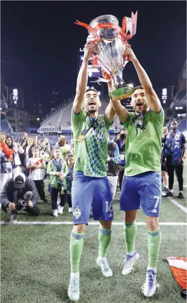  ?? Agence France-presse ?? Alex Roldan (left) and Cristian Roldan of Seattle Sounders celebrate with the trophy after winning the CONCACAF Champions League final.