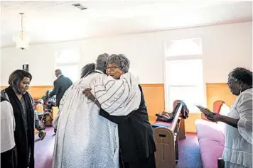  ?? AUDRA MELTON/THE NEW YORK TIMES PHOTOS ?? The Rev. Michelle Rizer-Pool hugs congregant­s at the Bethel African Methodist Episcopal Church, in Gainesvill­e, Georgia.