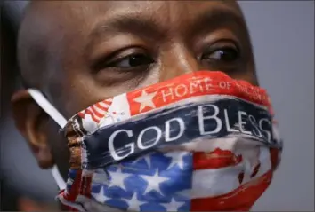  ?? Chip Somodevill­a/Getty Images ?? Sen. Tim Scott, R.-S.C., the only African American Republican senator, talks to reporters Tuesday after the weekly Senate Republican policy luncheon in the Hart Senate Office Building on Capitol Hill in Washington, D.C.