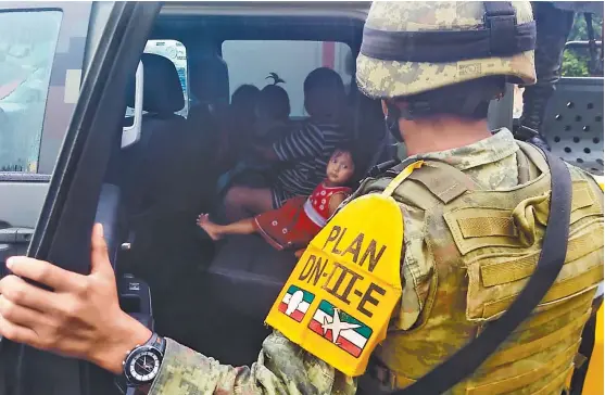  ??  ?? Militares trasladan a una mujer y sus hijos a un lugar seguro, como parte del Plan DN-IIIE en su fase preventiva.