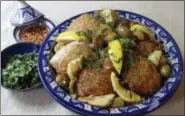  ?? SARA MOULTON VIA AP ?? Couscous with baked chicken, green olives, lemons and artichoke hearts.