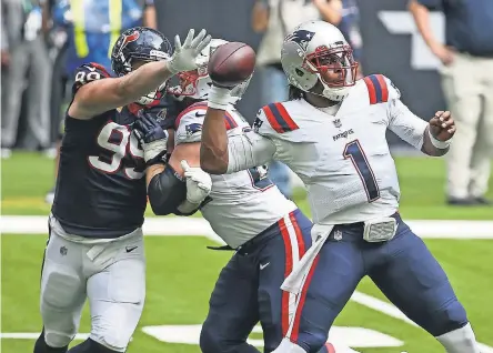  ?? TROY TAORMINA/ USA TODAY SPORTS ?? Patriots quarterbac­k Cam Newton throws as Texans defensive end JJ Watt applies pressure during the third quarter Sunday. The 27- 20 loss to Houston dropped New England to 4- 6.