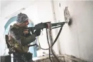  ?? THE ASSOCIATED PRESS ?? A Federal Police soldier shoots toward Islamic State militant positions during fighting Thursday in western Mosul, Iraq.