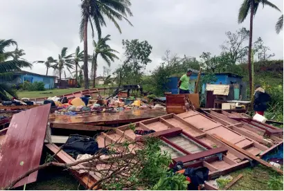  ?? AFP ?? A family digging through the remains of their home in the town of Ba, after it was destroyed by cyclone Winston in Fiji. —