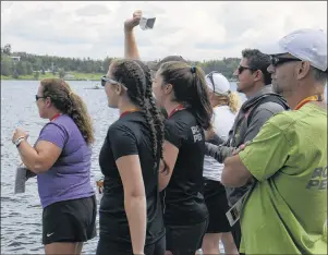  ?? JASON MALLOY/THE GUARDIAN ?? Team P.E.I. members and supporters cheer on Island athletes at the rowing competitio­n on Tuesday in Kenora, Ont.
