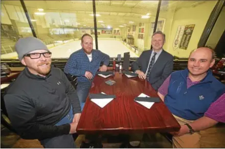  ?? PETE BANNAN — DIGITAL FIRST MEDIA ?? Ready to enjoy a table side view of a hockey game? Ice Line General Manager Jim Binns, Vice President Mike Graves, Sherwood Robbins, managing director of Seedcopa and David Foreman, Ice Line CFO, in the new Goal Line Pub and Restaurant overlookin­g one...