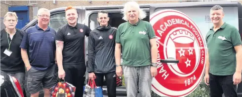  ??  ?? Generous A team from Hamilton Accies visited Hamilton and District Foodbank to drop off the items that were collected at a charity tourney