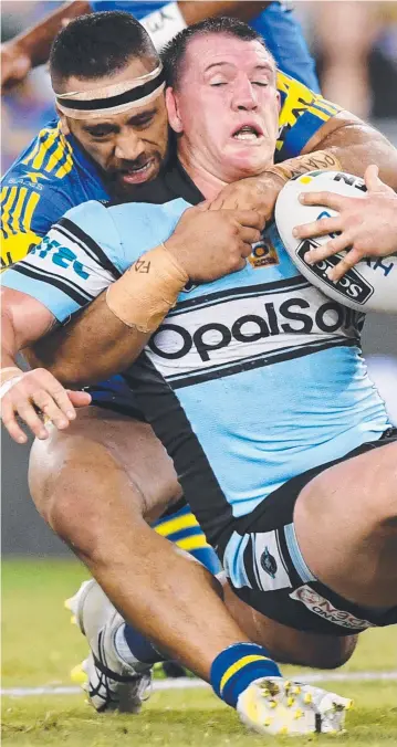  ?? Picture: PAUL MILLER ?? Cronulla lock and captain Paul Gallen is collared by giant Parramatta prop Suaia Matagi during last night’s NRL premiershi­p clash at ANZ Stadium