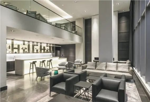  ?? Photograph­y by Steelblue ?? Lumina includes a two-level club lounge with a marble fireplace and a backlit bar.