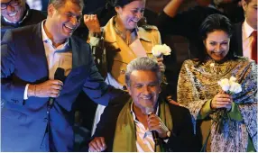  ?? (Mariana Bazo/Reuters) ?? ECUADOREAN PRESIDENT-ELECT Lenin Moreno (center) celebrates alongside his wife, Rocio Gonzalez, and Ecuadorean President Rafael Correa in Quito on Sunday night.