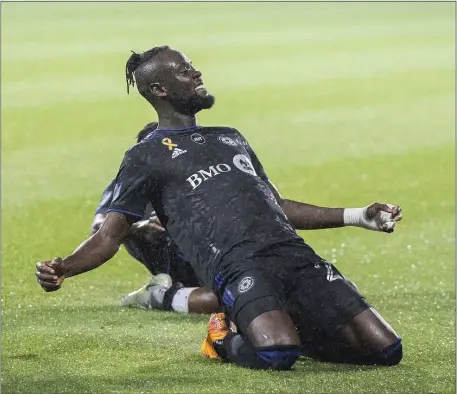  ?? AP FILE ?? SLIP AND SLIDE: CF Montreal’s Kei Kamara celebrates after scoring against the Chicago Fire on Tuesday.