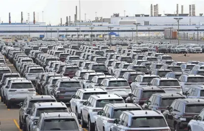  ?? ?? New vehicles are shown parked in storage lots near the the Stellantis Detroit Assembly Complex in Detroit on Oct. 5. Over the past few years, thieves have driven new vehicles from storage lots and dealership­s across the Detroit area.