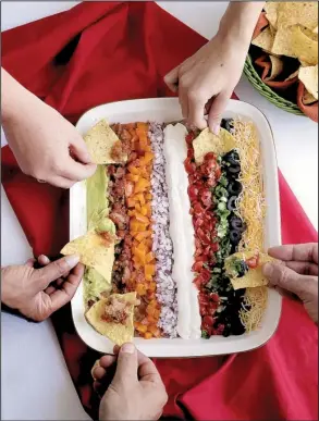  ?? St. Louis Post- Dispatch/ TNS/ CRISTINA M. FLETES ?? Garden in a Pan is a pretty twist on seven layer dip.