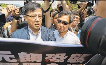  ?? Kin Cheung Associated Press ?? JUNIUS HO, left, is hated by protesters who suspect the Hong Kong politician of ties to attacks against them.