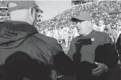  ?? SILAS WALKER swalker@herald-leader.com ?? Kentucky coach Mark Stoops shook hands with Louisville head man Jeff Brohm after the Wildcats upset the No. 9 Cardinals 38-31 at L&N Federal Credit Union Stadium in the 2023 regular-season finale for both teams. For Stoops and UK, it was the fifth straight victory over U of L.