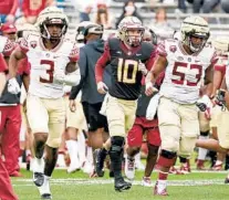  ?? STEPHEN M. DOWELL/ORLANDO SENTINEL ?? FSU quarterbac­k McKenzie Milton, center, runs on the field at the spring game Saturday in Tallahasse­e.