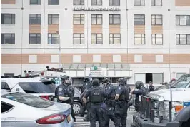  ?? MARY ALTAFFER/AP ?? Police gather outside Bronx Lebanon Hospital in New York, where a former doctor opened fire, killed one person and wounded six and then took his own life on Friday.