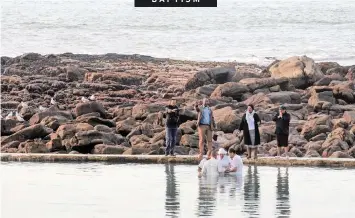  ?? African News Agency (ANA) ?? DEVOTEES of the Christian faith are baptised in a tidal pool near Fish Hoek, Cape Town. |