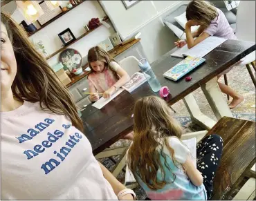  ?? AMBER CESSAC VIA AP ?? Amber Cessac takes a selfie as her daughters do their homework at their home in Georgetown, Texas. A year and a half in, the pandemic is still agonizing families. There is still the exhaustion of worrying about exposure to COVID-19itself,