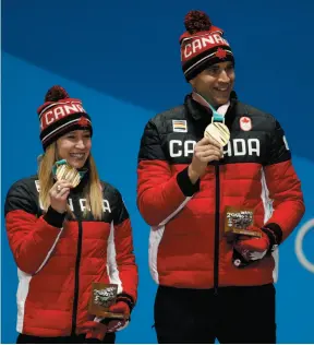  ?? CP PHOTO ?? Curling mixed doubles gold medalists Kaitlyn Lawes and John Morris of Canada smile during a medals ceremony at the 2018 Winter Olympics in Pyeongchan­g, South Korea, on Wednesday.