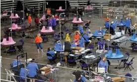  ?? Photograph: Matt York/AP ?? Contractor­s working for Florida-based company Cyber Ninjas examine and recount Maricopa county ballots cast in the 2020 general election in Phoenix on 6 May 2021.