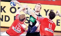  ??  ?? Germany’s Paul Drux (center), vies with Denmark’s Rene Toft Hansen (right), and Rasmus Lauge Schmidt (right), during the Group II match of the Men’s 2018 EHF European Handball Championsh­ip between Germany
and Denmark in Varazdin on Jan 21. (AFP)