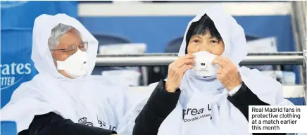  ??  ?? Real Madrid fans in protective clothing at a match earlier this month