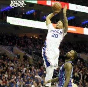  ?? MICHAEL PEREZ — THE ASSOCIATED PRESS ?? The 76ers’ Markelle Fultz (20) goes up for a dunk as Charlotte’s Michael Kidd-Gilchrist (14) defends Saturday.