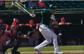  ?? MATT YORK — THE ASSOCIATED PRESS ?? Oakland Athletics first baseman Matt Olson hits against the Cincinnati Reds during a spring training game Monday in Mesa, Ariz.