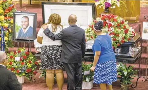  ?? AP ?? Mourners console each other as they pause by coffin of Botham Jean (below left), who was shot by off-duty cop Amber Guyger (below right). Anger has erupted after the discovery of marijuana in Jean’s apartment, which Guyger had barged into by mistake before the slay.