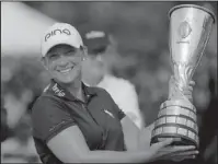  ?? The Associated Press ?? NATURAL CHAMPION: Angela Stanford poses Sunday with her trophy after winning the Evian Championsh­ip women’s golf tournament in Evian, eastern France.