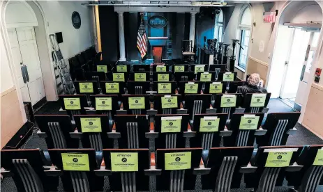  ?? OLIVER CONTRERAS/THE NEW YORK TIMES ?? Signs on seats encourage social distancing Friday in a nearly empty James S. Brady Briefing Room at the White House.