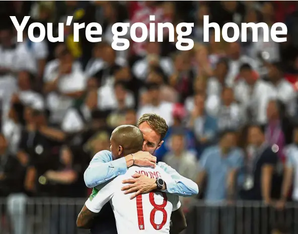  ?? — AFP ?? We’re done: England manager Gareth Southgate consoling defender Ashley Young after their semi-final loss to Croatia at the Luzhniki Stadium on Wednesday.