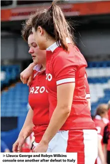  ?? ?? Lleucu George and Robyn Wilkins console one another after defeat to Italy