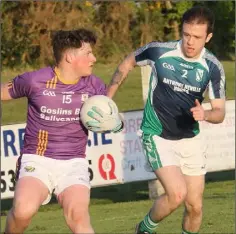  ??  ?? Ashley Tully of St. Patrick’s sizes up his options as Jason Kearns (Volunteers) closes him down in Friday’s IAFC game in Oylegate.