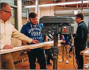  ?? COURTESY OF ONEIDA HIGH SCHOOL ?? OHS Technology teacher Robert Straczuk and students pre-building components to the tiny house.