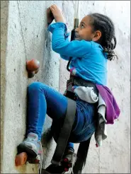  ?? NWA Democrat-Gazette/DAVID GOTTSCHALK ?? Soletta Willis approaches the top of the climbing wall as she participat­es in the Thanksgivi­ng Week Camp at the Boys & Girls Club in Fayettevil­le. The club is one of several nonprofit organizati­ons making wishes this holiday season.