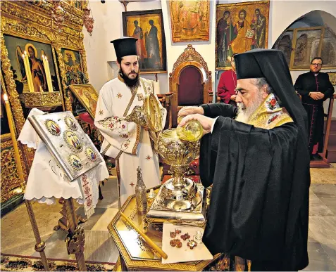  ?? ?? Oils from the Mount of Olives are mixed with essential oils by the Patriarch of Jerusalem, His Beatitude Patriarch Theophilos III, to be used in the blessing of King Charles III